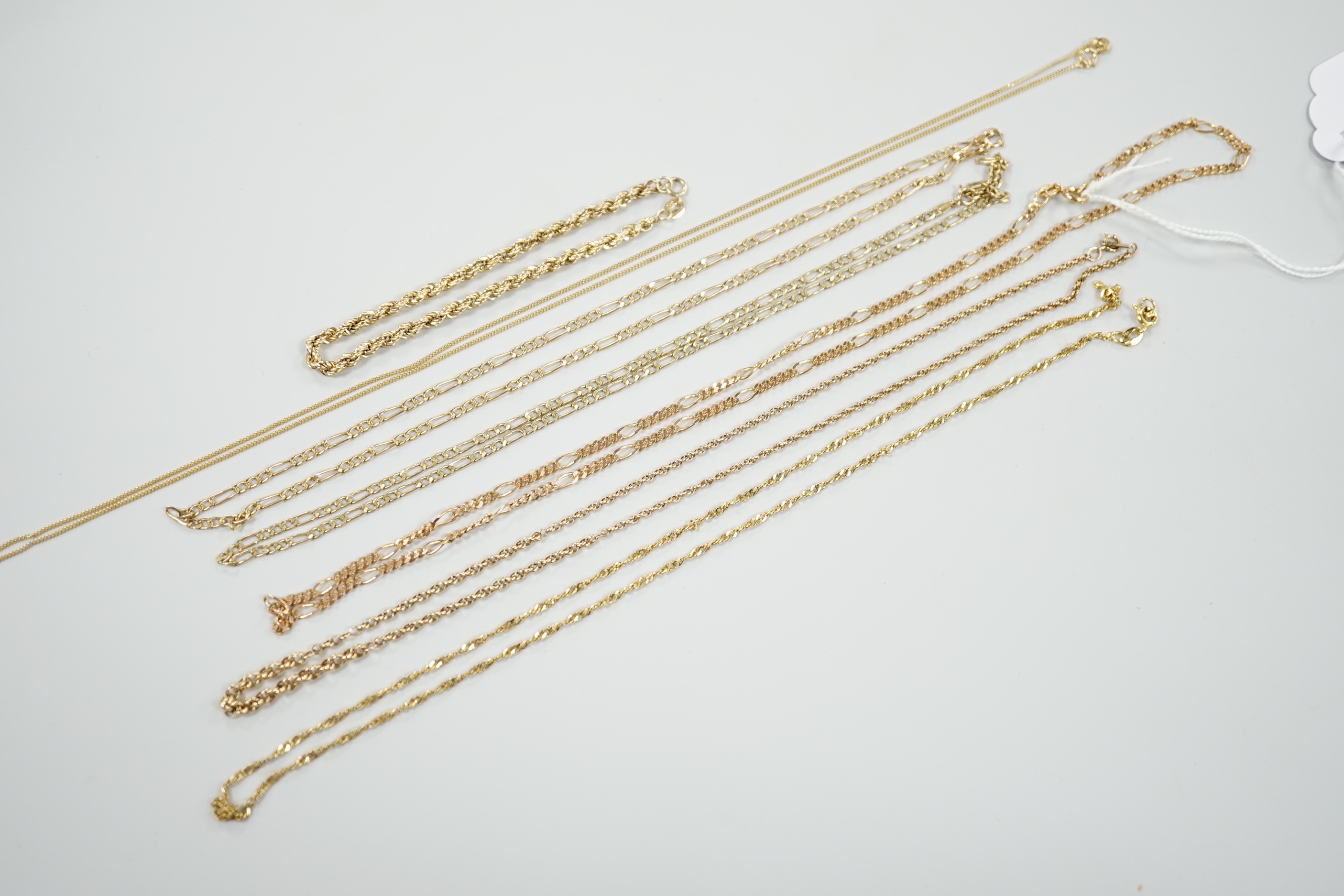 Six assorted modern 9ct gold chains, longest 54cm and a 9ct gold rope twist bracelet, 18cm, 18.5 grams.